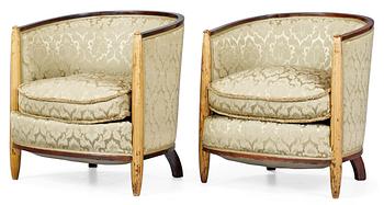 A pair of French partly gilt palisander armchairs in the manner of Poul Follot, 1920-30's.