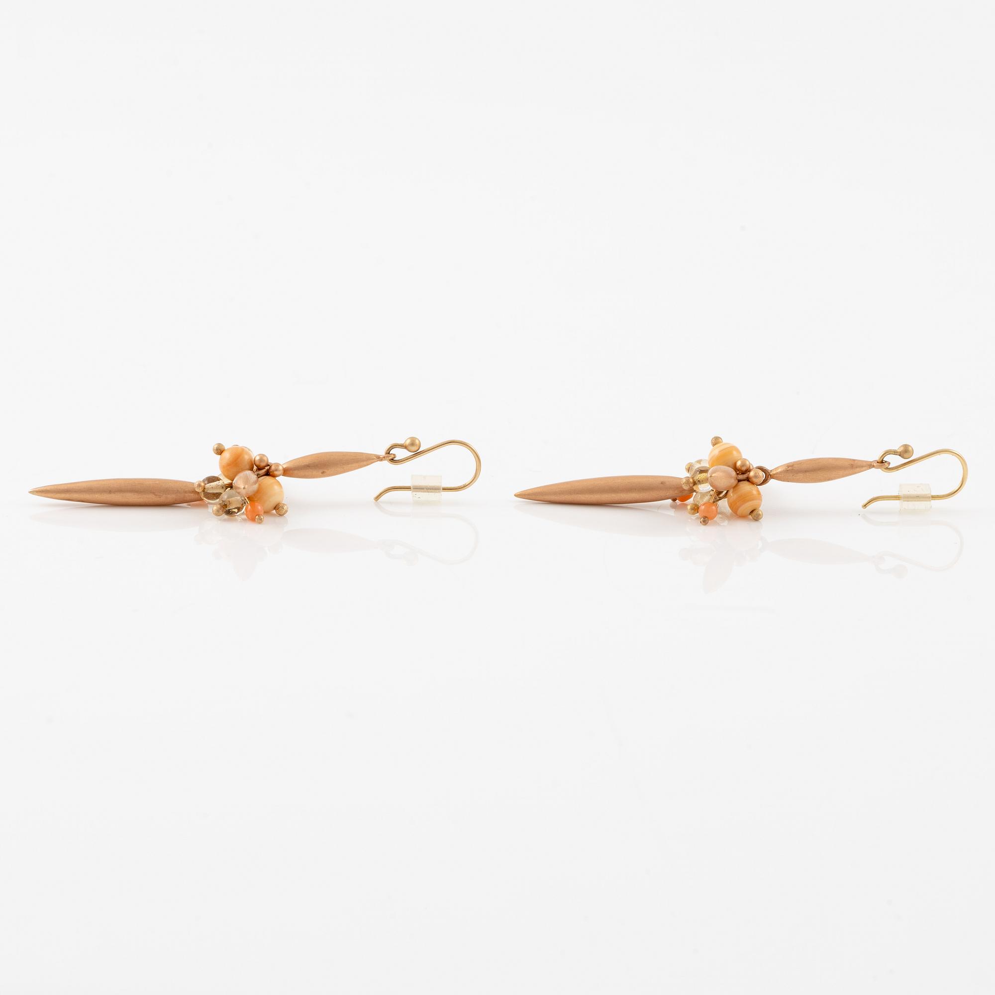 A pair of earrings in 14K and 9K gold with coral and quartz, by Ted Muehling purchased at Svenskt Tenn.