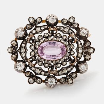 429. A 14K gold and silver brooch set with an oval faceted pink topaz and old- and rose-cut diamonds.