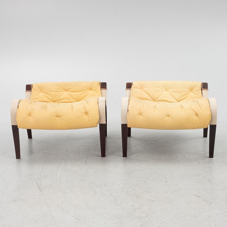 Bruno Mathsson, a pair of "Pernilla" armchair with ottoman, Dux, Sweden, second half of the 20th century.