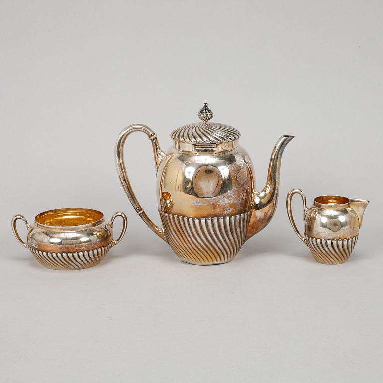 A silver coffee pot, creamer and sugar bowl, mark of Carl August Björklund, Stockholm 1900.