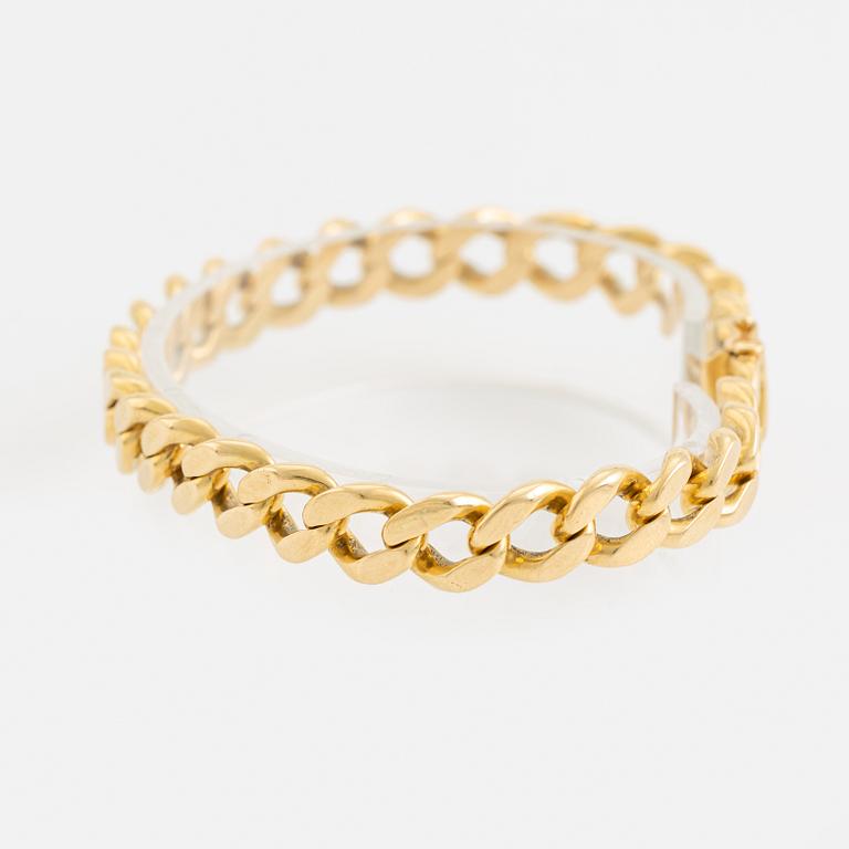 18K gold curb link bracelet.