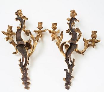 A pair of Louis XV mid 18th century three-light wall-lights.