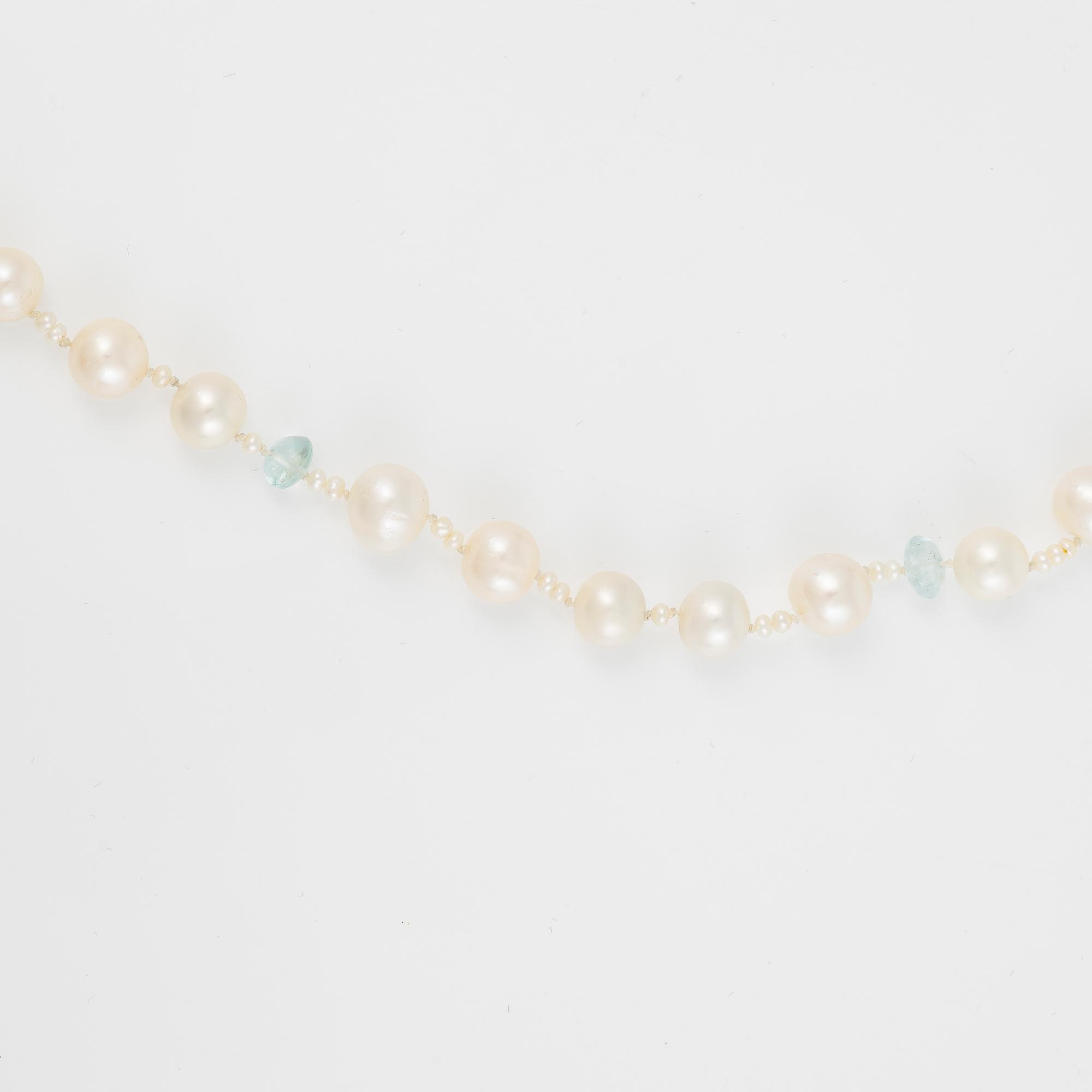 Ole Lynggaard clasp in 18K gold with a necklace of cultured freshwater pearls.