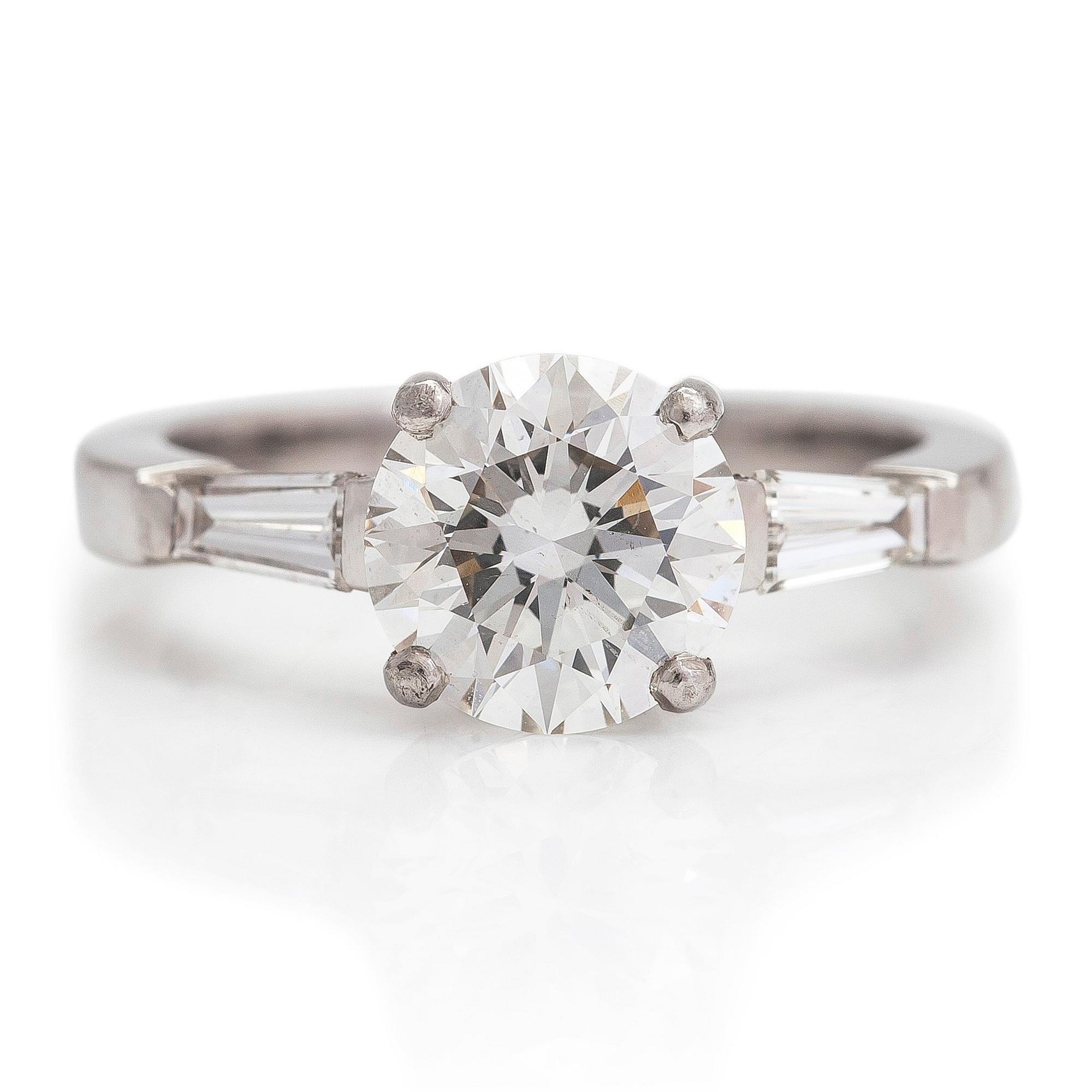 A platinum ring with a brilliant cut diamond ca 1.80 ct and two side-diamonds totalling ca 0.10 ct. With certificate.