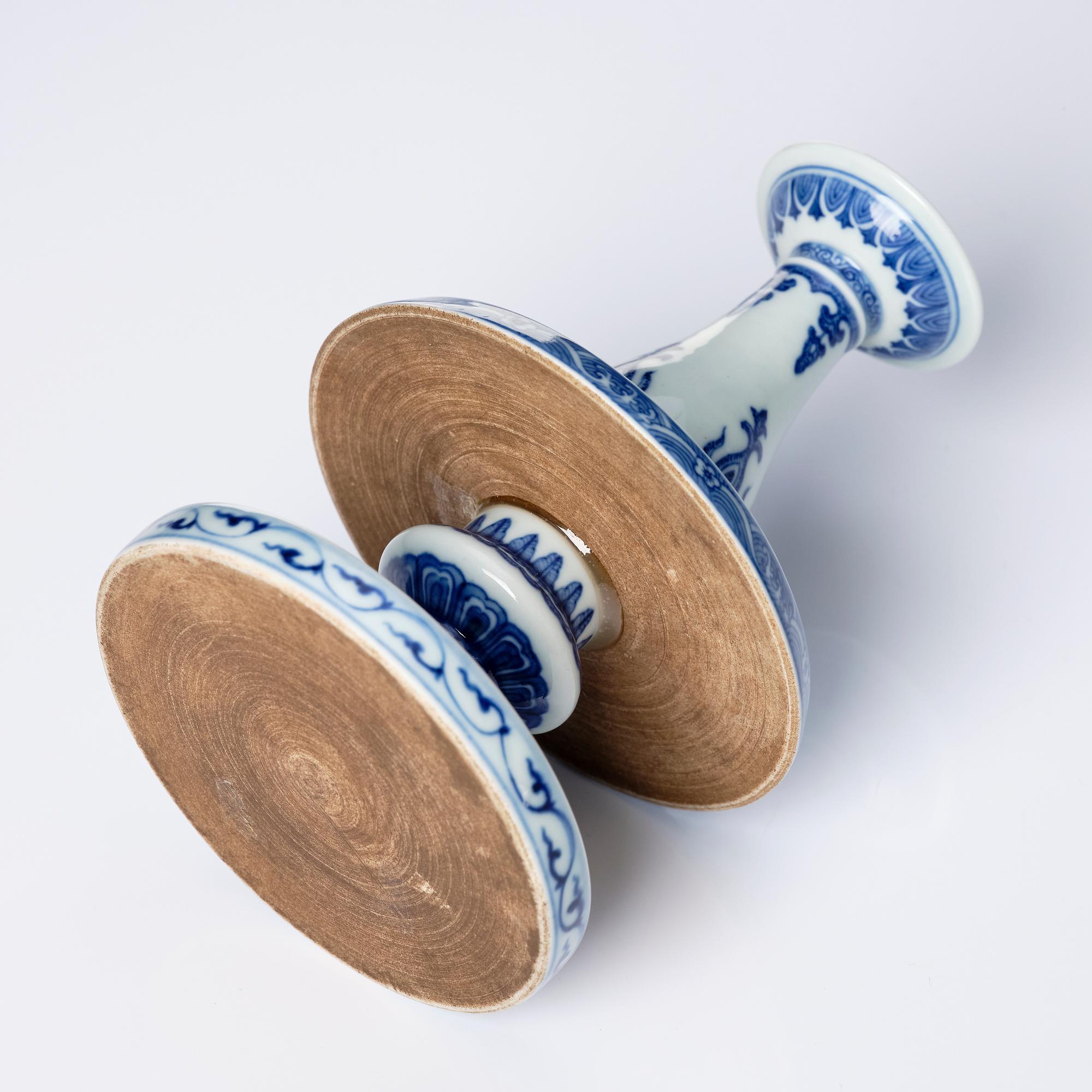 A pair of blue and white pricket candle sticks, with a poem, Qing dynasty with a Qianlong mark and of the period.