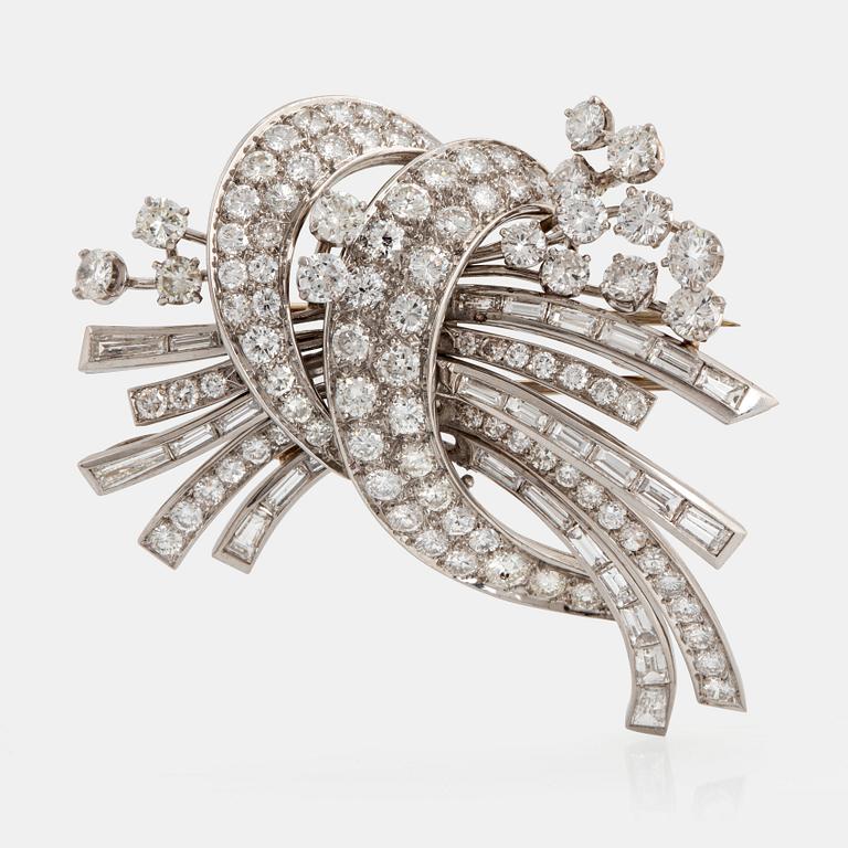 A platinum and 18K gold brooch set with round brilliant- and baguette-cut diamonds.