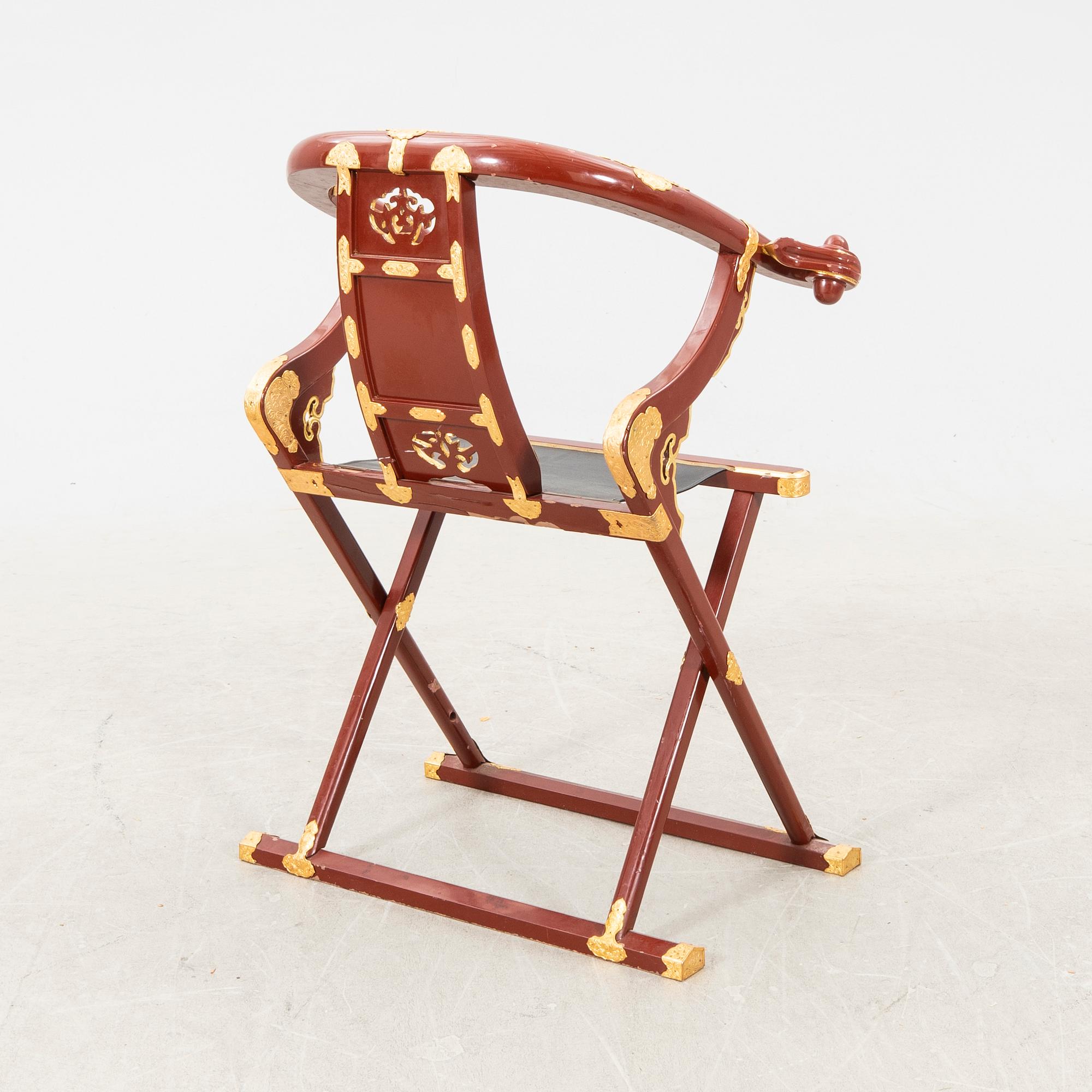 A laqcuered wooden chair from China 21st century.