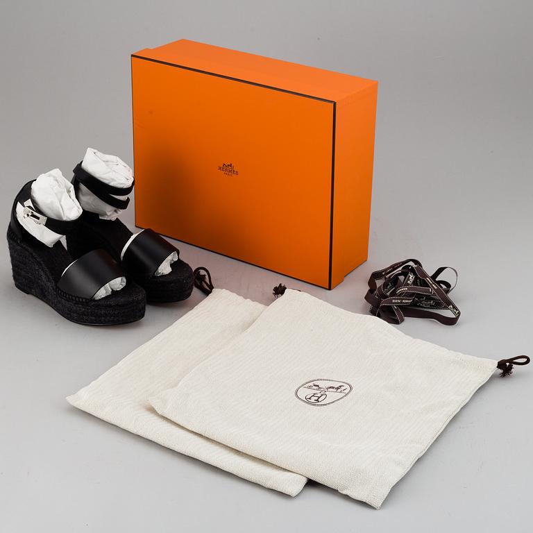 HERMÈS, a pair of black leather 'Tivoli' wedge sandals, 2019, size 38.
