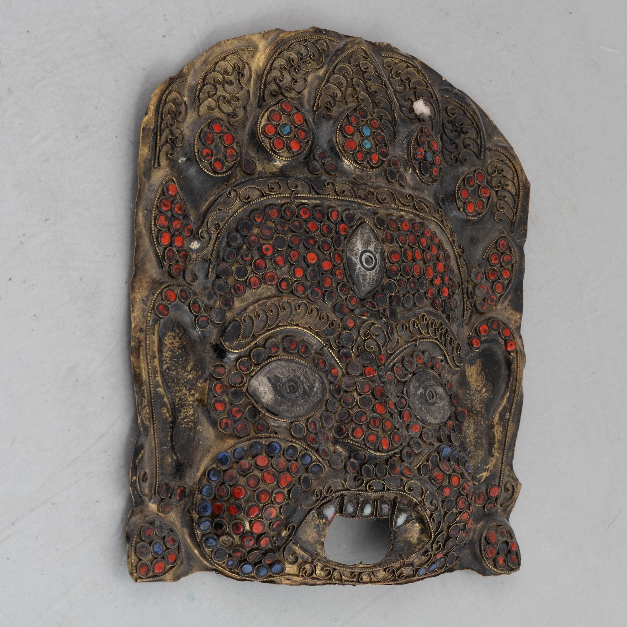 A stone inlay mask, Nepal, early 20th century.