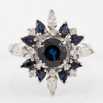 Ring 18K white gold with dark sapphires, pear-shaped and brilliant-cut diamonds.