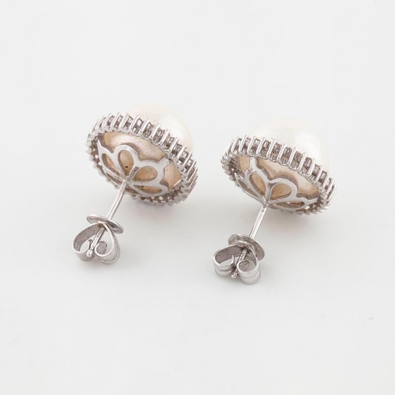 A pair of mabe pearl and brilliant cut diamond earrings.