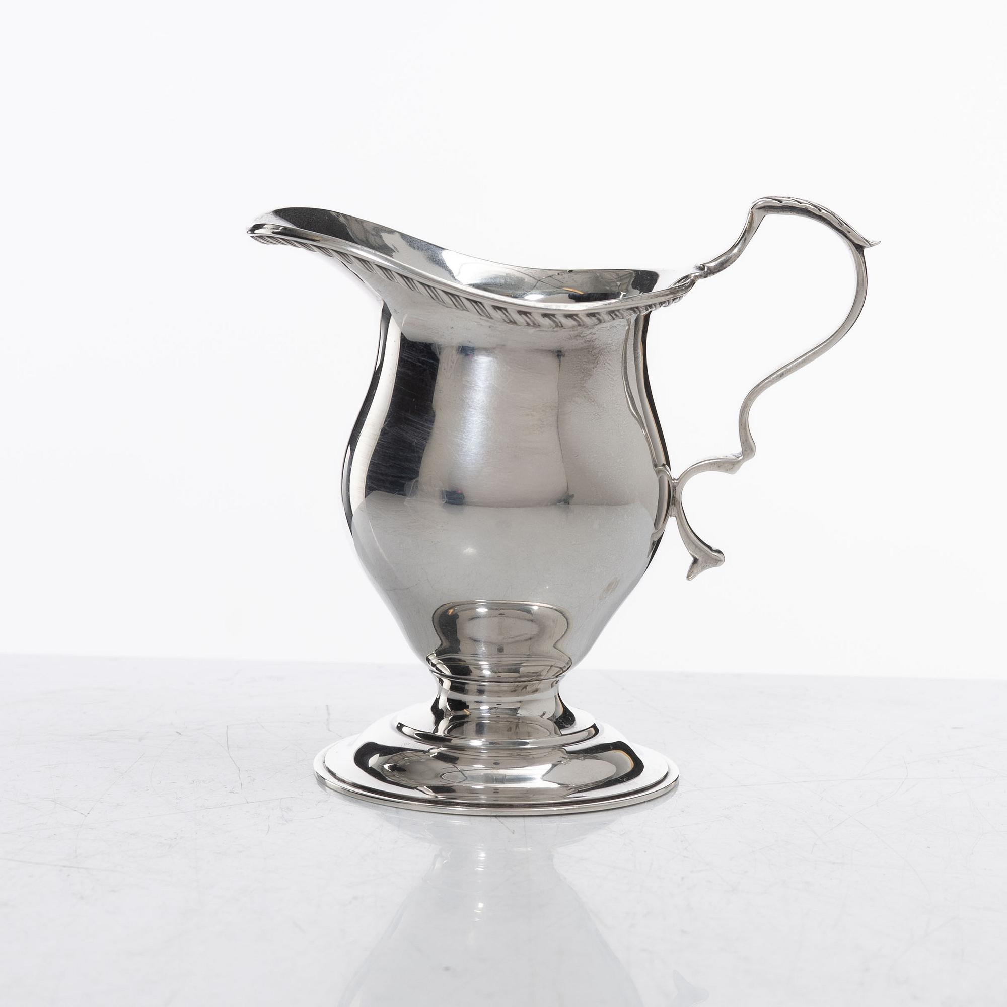 A silver cream jug, mark of S W Smith & Co, Birmingham, England 1929.