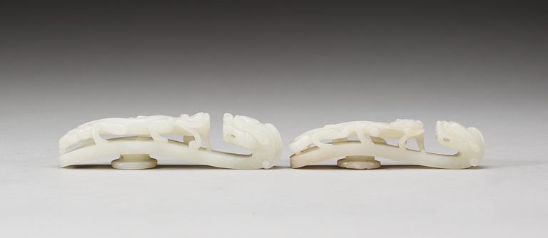 Two pale green nephrite garment hooks, Qing dynasty.