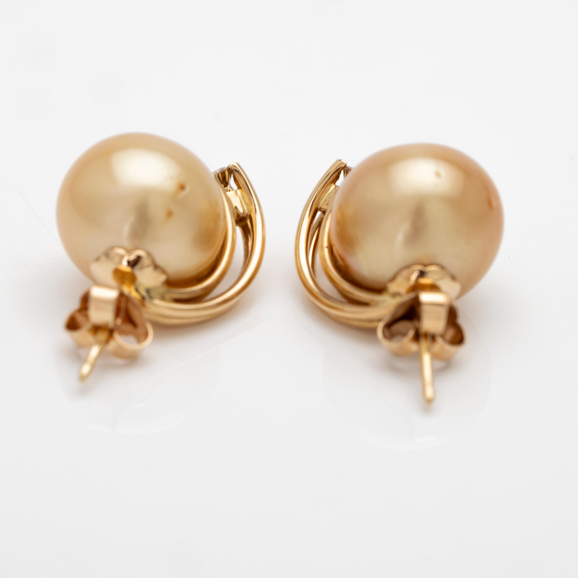 18K gold earrings with South Sea pearls and diamonds.