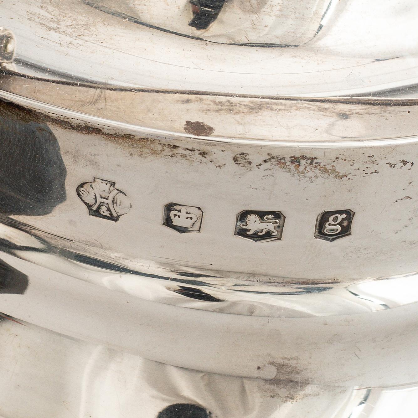 A silver teapot, coffee pot and a hot water pot, including Atkins Brothers, Sheffield 1944.