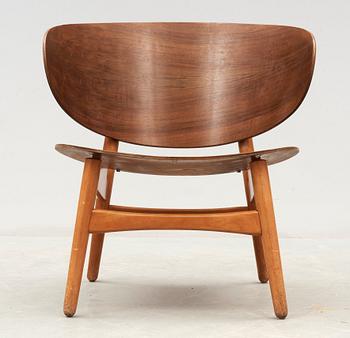 A Hans J Wegner mahogany and beech easy chair, Denmark 1950's.