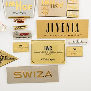 A collection of shop signs and agent plaques from Swiss watchmakers.
