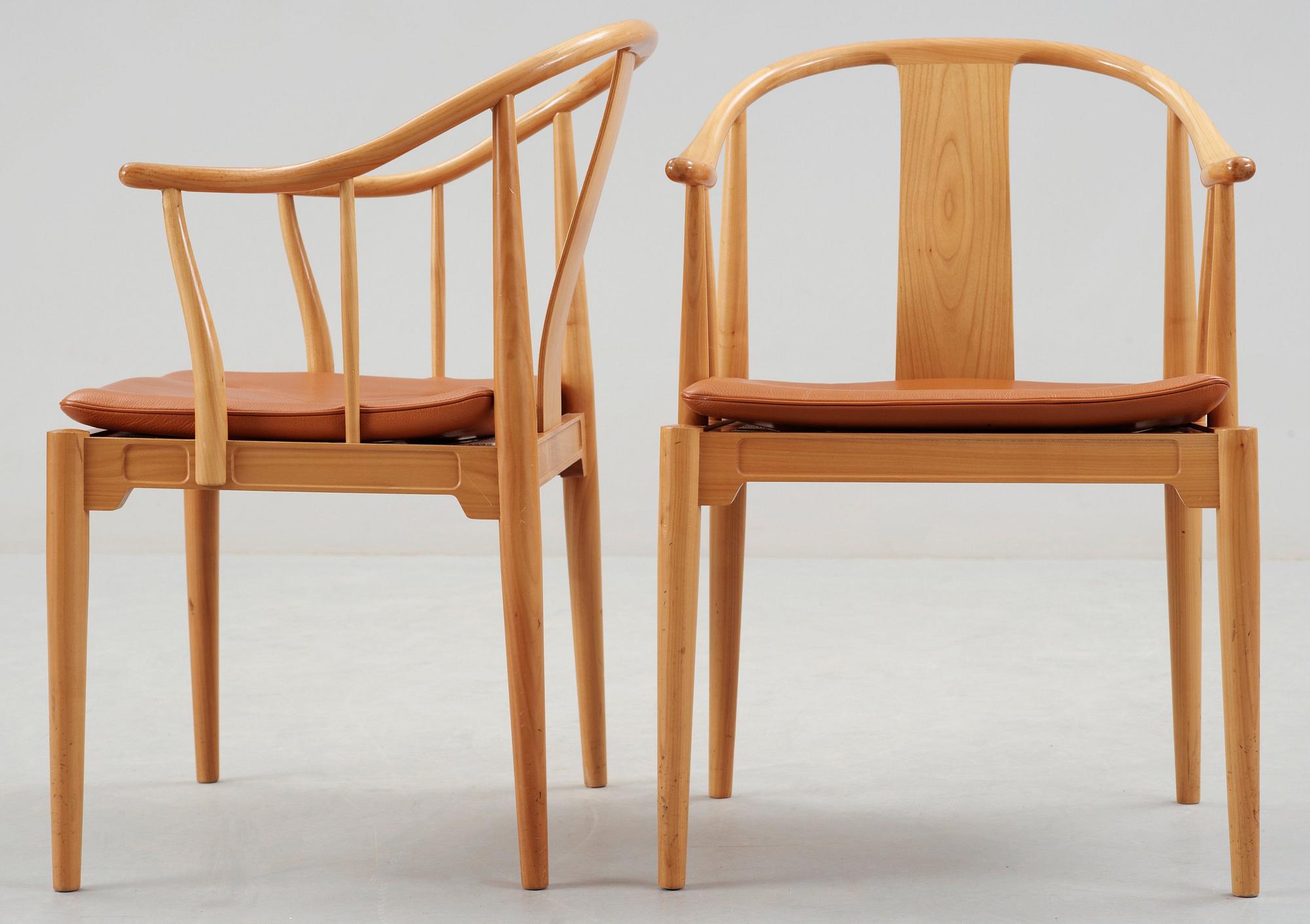 A pair of Hans J Wegner cherry and brown leather 'China chairs', Fritz Hansen, Denmark 1989.