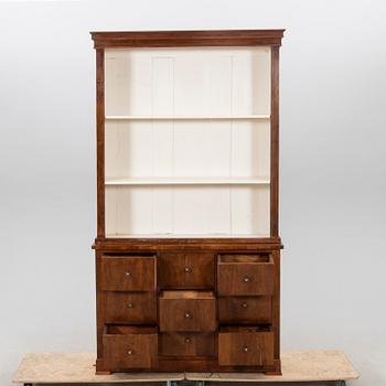 A stained walnut cabinet from the first half of the 20th century.