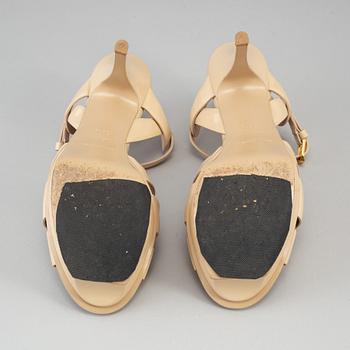 YVES SAINT LAURENT, a pair of open toe patent leather shoes, size 36½.