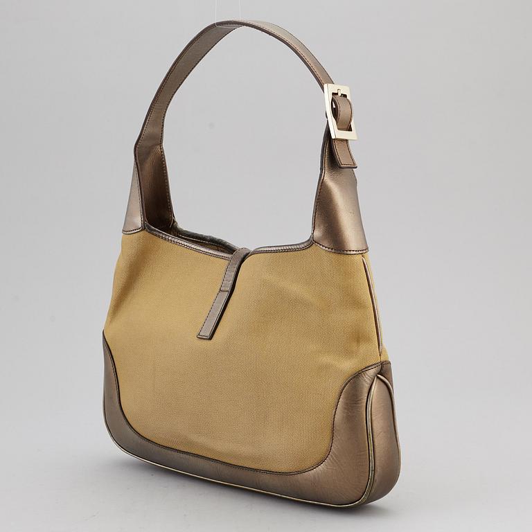 GUCCI, a metallic bag.