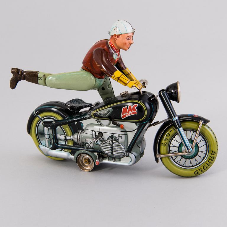 ARNOLD, a Mac 700 motorcycle, Germany, 1950's and a Joustra "Gigi" figure France 1950s. Both in original boxes.