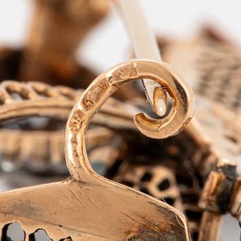 A 14K gold brooch set with old-cut diamonds.