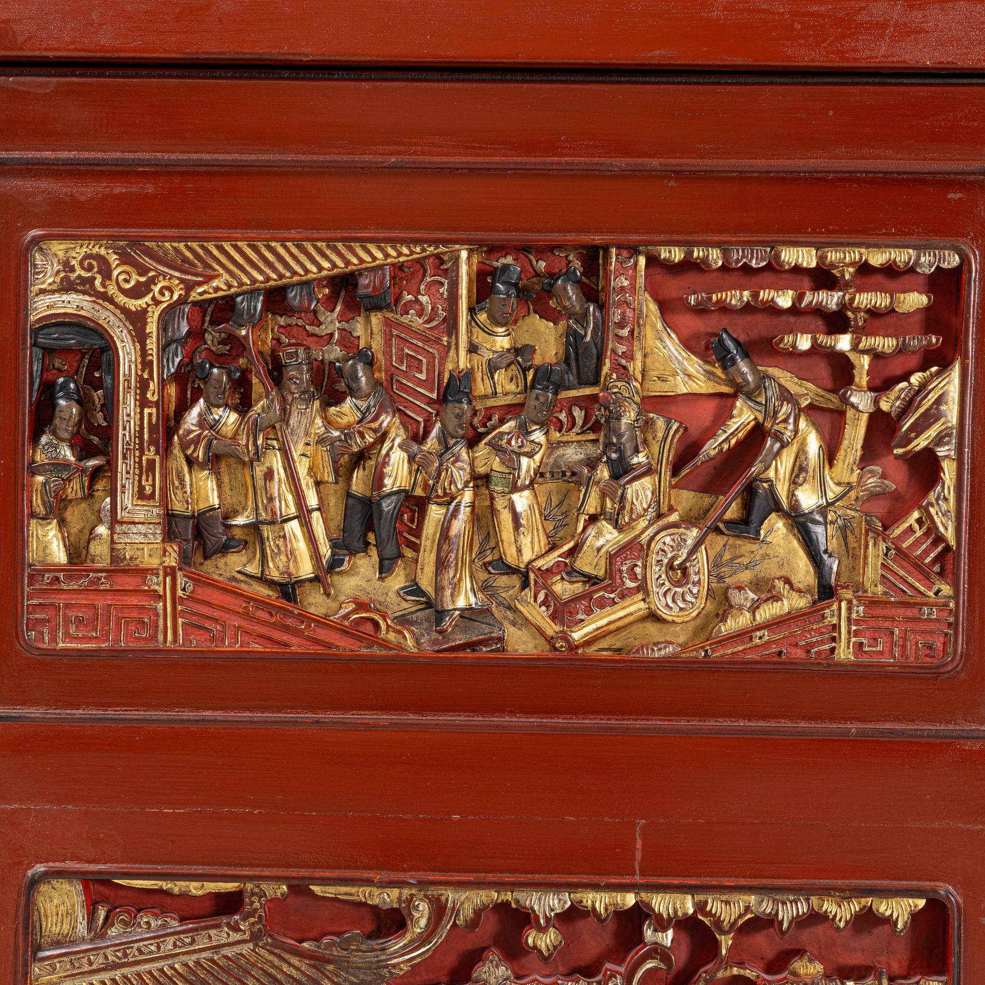 A Chinese cabinet, early 20th Century, with 19th Century carved panels.