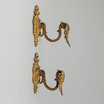 Three pairs of bronze and brass tie-backs, 19th century.