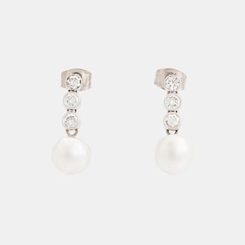 A pair of 18K white gold earrings set with pearls and round brilliant-cut diamonds.