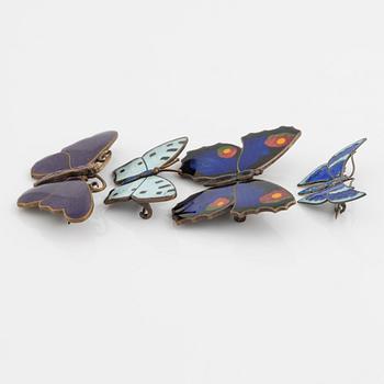 Four silver and enamel butterfly brooches.