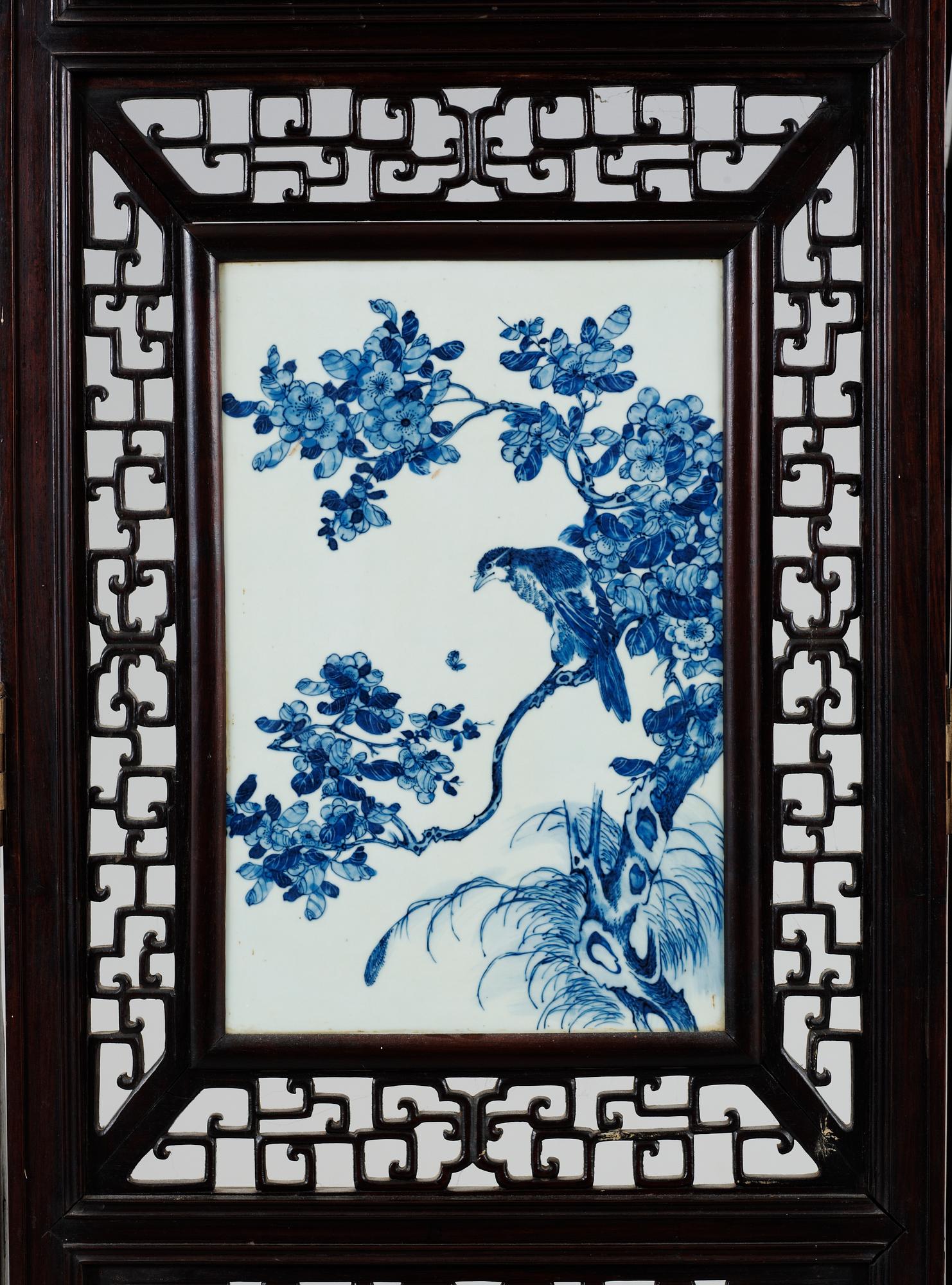 A four panel screen with porcelain placques, Qing dynasty, 19th Century.