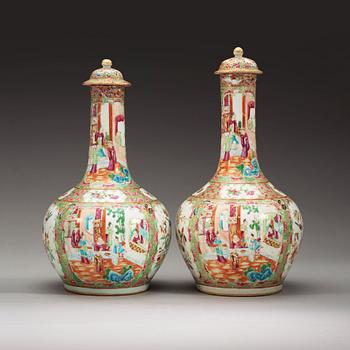 309. A pair of famille rose Canton vases with covers, Qing dynasty, 19th Century.