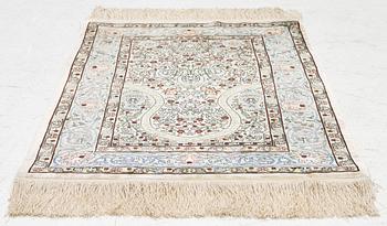 A silk Hereke rug, Turkey, approx. 82 x 58 cm.