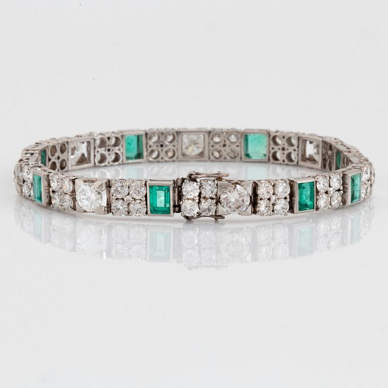 A platinum bracelet set with round brilliant- and old-cut diamonds and faceted emeralds.