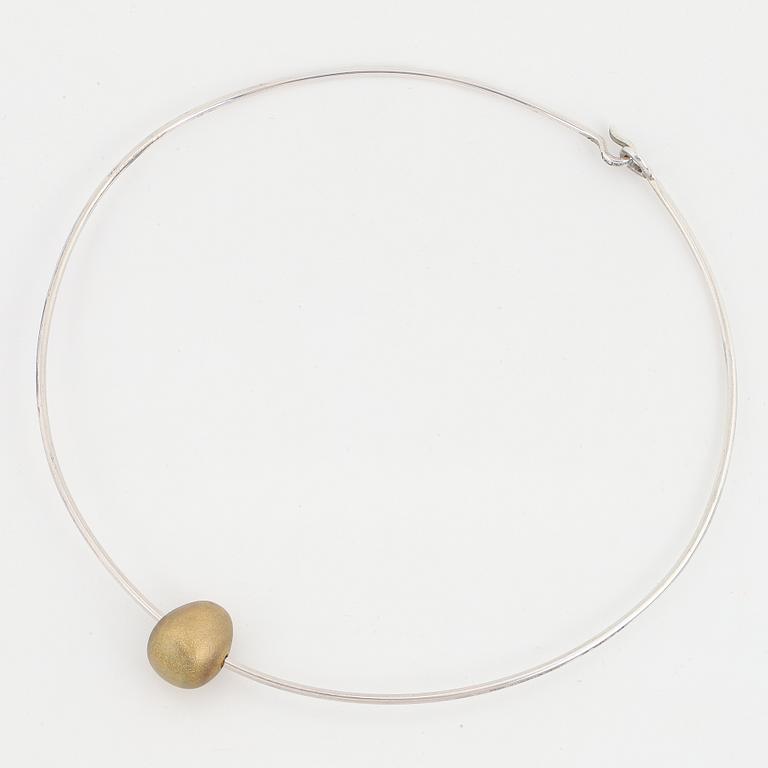 Gunilla Lantz, silver and gilded egg necklace.