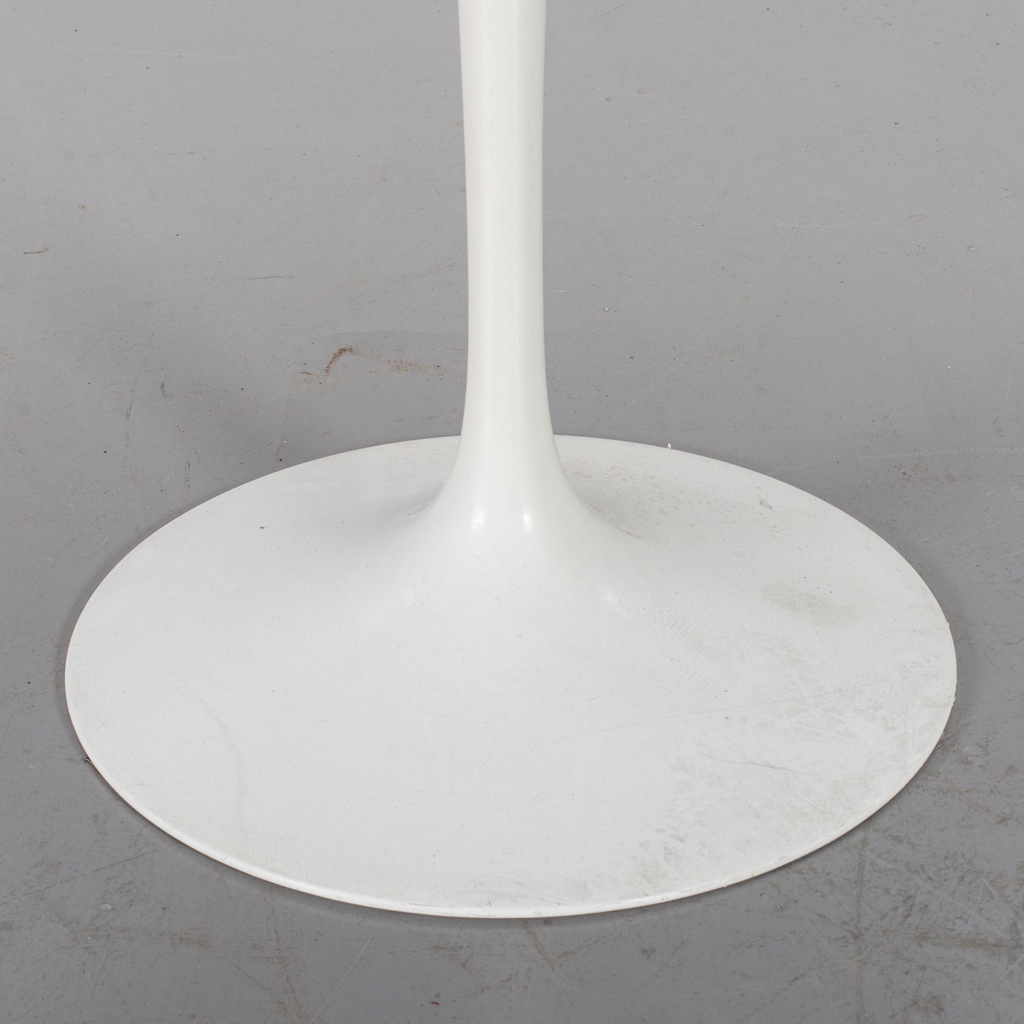 AN EERO SAARINEN "TULIP" TABLE BY KNOLL INTERNATIONAL.