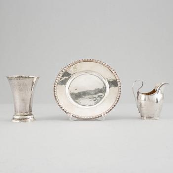 Beaker, silver 1835, cream-jug, silver 1826 and bread-plate, silver 1952.