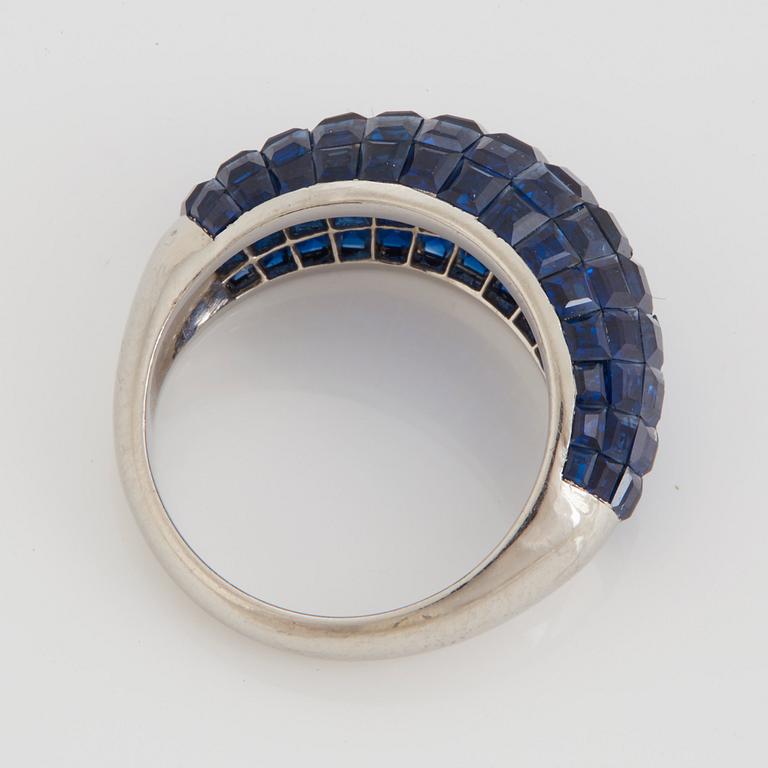 A platinum ring set with carre cut sapphires 6.28 cts according to engraving.