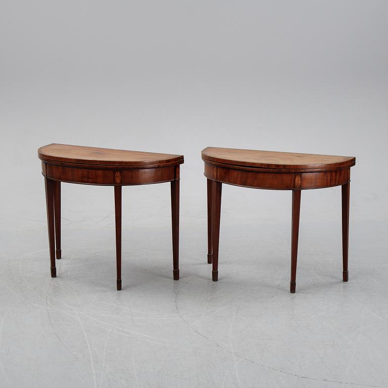 A pair of George III demi-lune mahogany card tables, first half of the 19th Century.