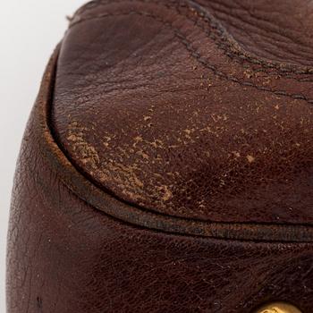 Prada, a brown leather bag.