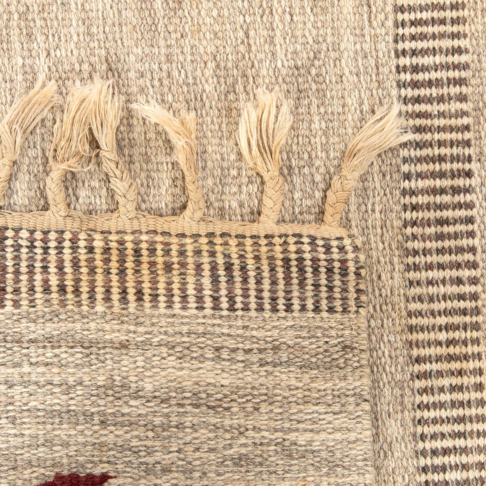 A Swedish flat weave carpet signed SH ca 243 x 162 cm.