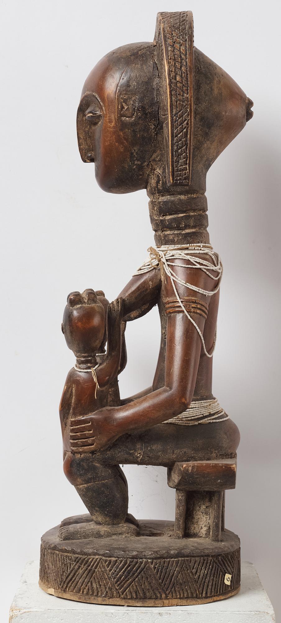 A sculptue and two masks reportedly from The Ivory coast, from the second half of the 20:th century.