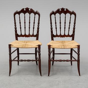 A pair of Chiavari chairs.