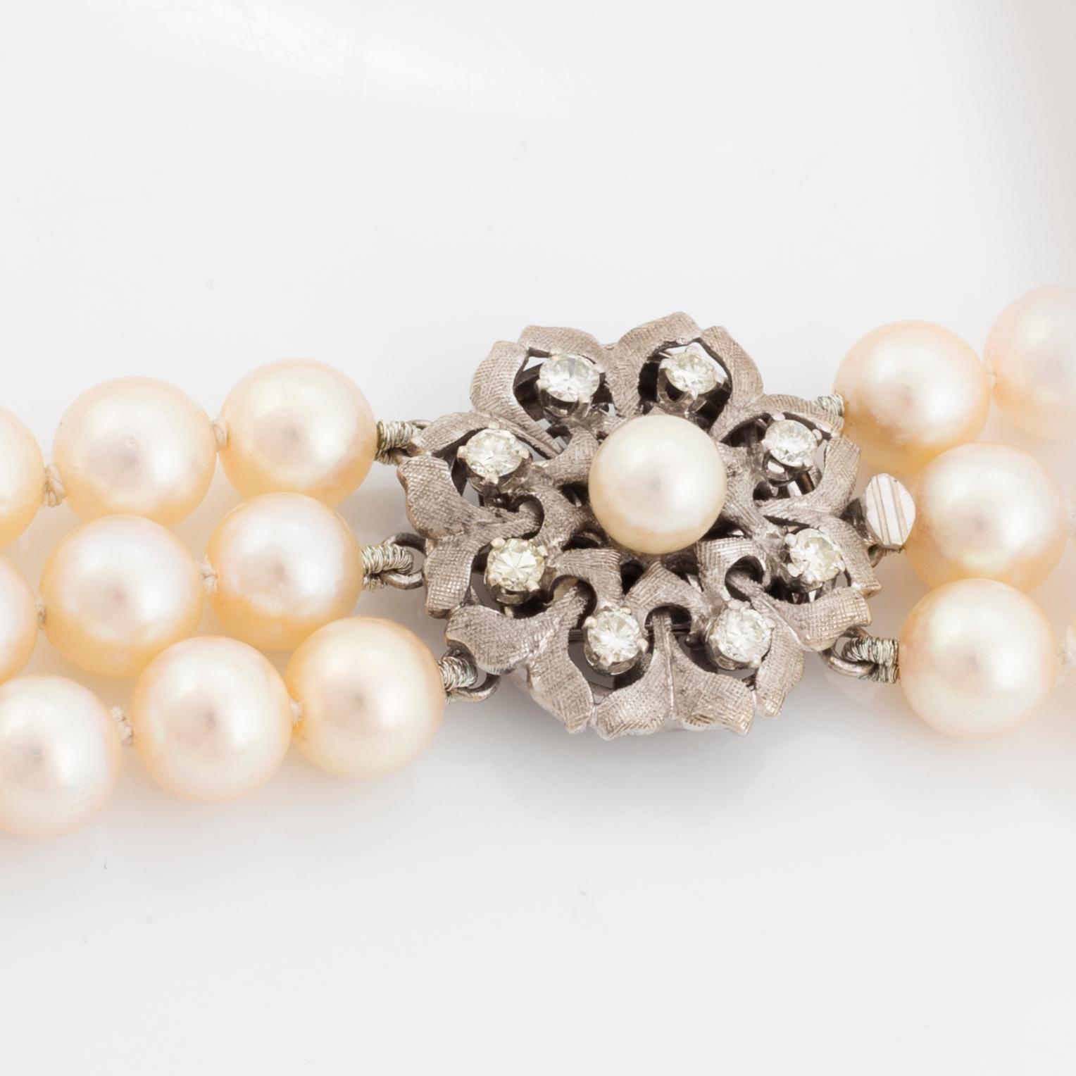 A three strand cultured pearl necklace.
