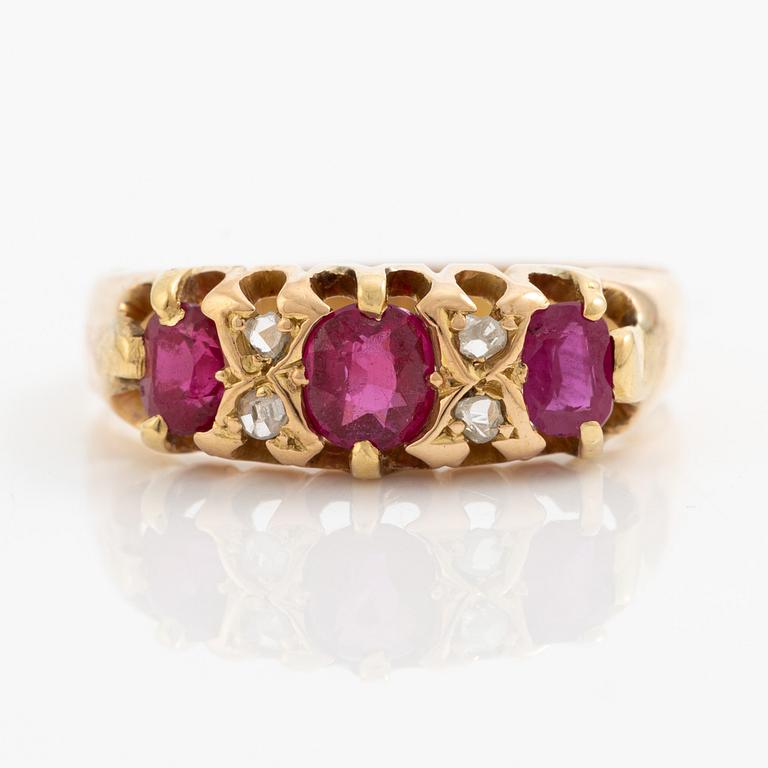 A ring 18K gold with rose-cut diamonds and red stones.
