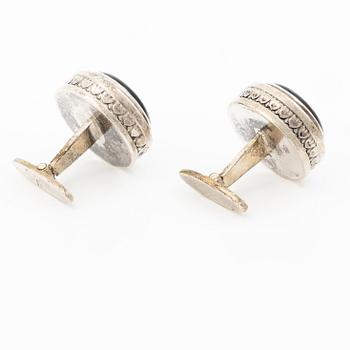 Cufflinks, a pair in silver with cabochon-cut stones.
