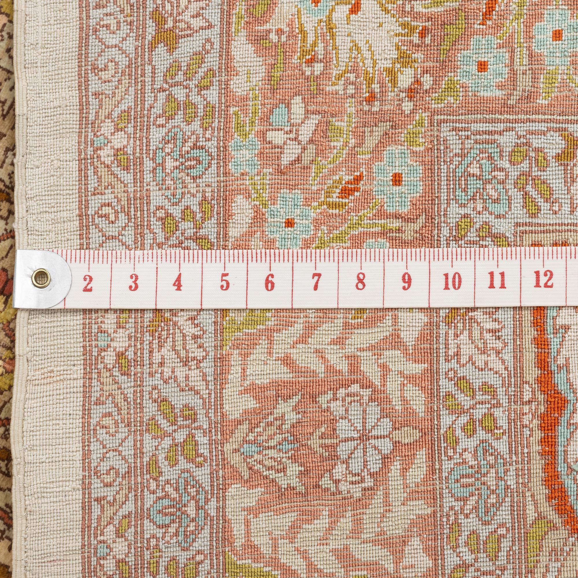 A silk Hereke rug, c. 85 x 55 cm.