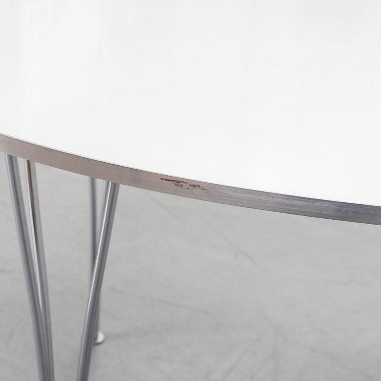 A 'Supercircular' table by Bruno Mathsson & Piet Hein for Fritz Hansen, dated 1985.